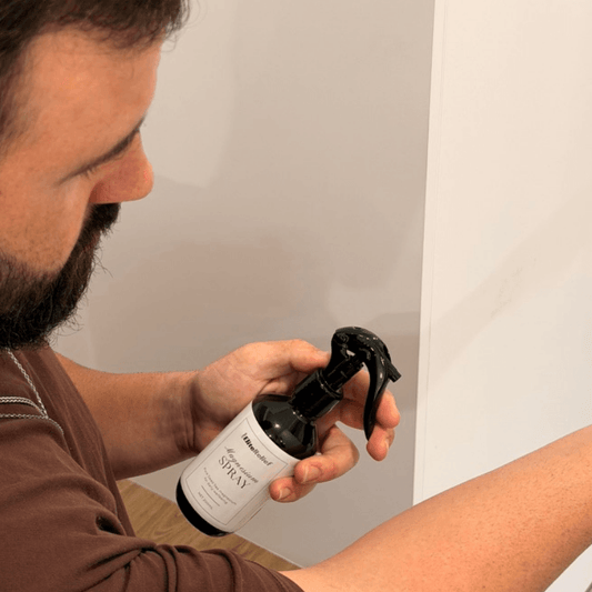 a man spraying magnesium on his wrist