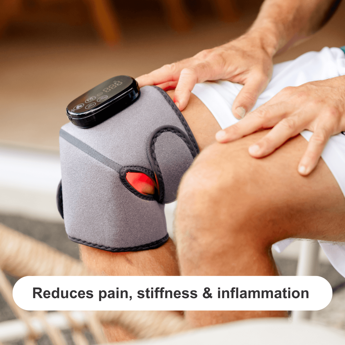 a man using a red light therapy joint wrap on his knee
