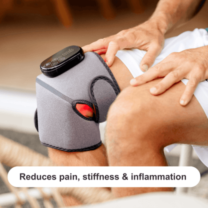 a man using a red light therapy joint wrap on his knee