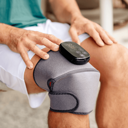 a man using a red light therapy joint wrap on his knee