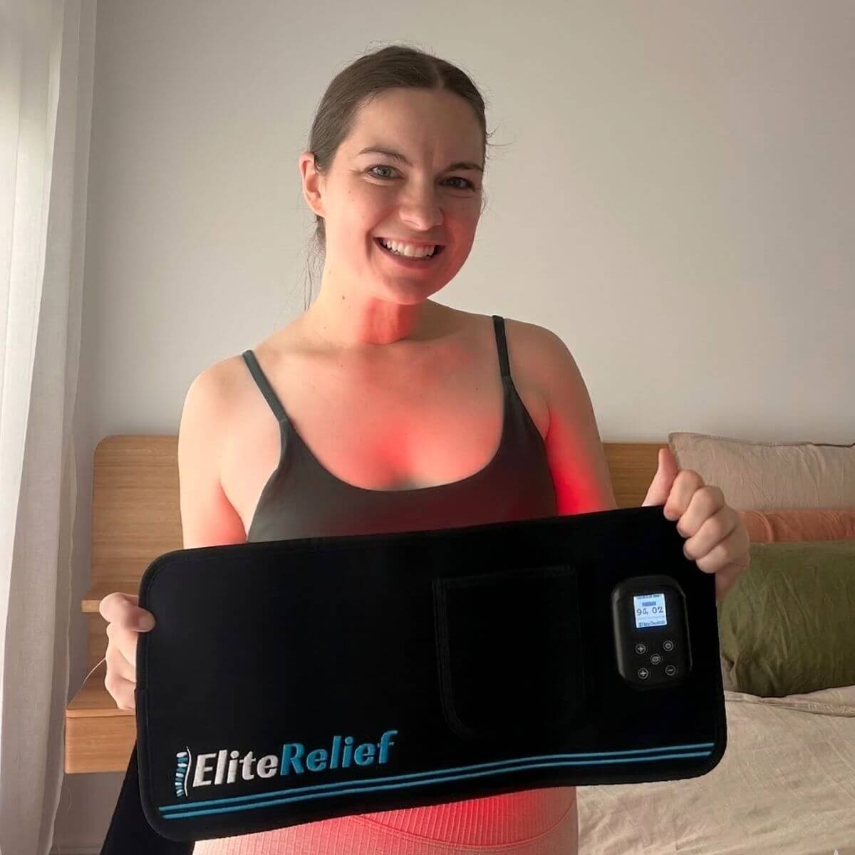 Woman holding the EliteRelief Red Light Therapy Belt PRO