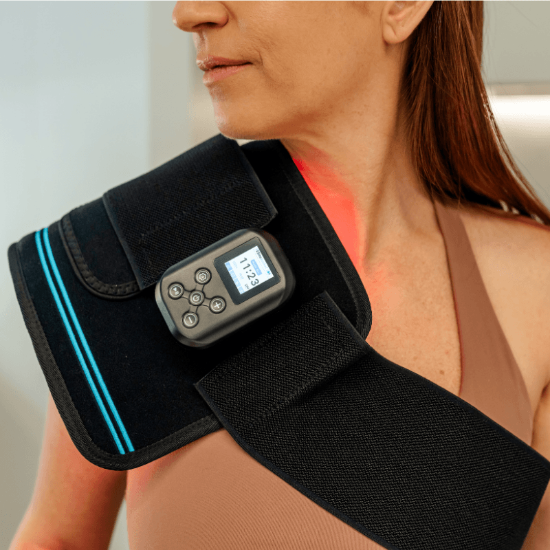 a woman using a Red Light Therapy Belt PRO on her shoulder
