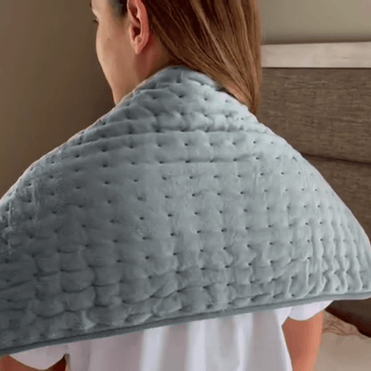 Product1 - Woman wearing a shoulder heating pad.